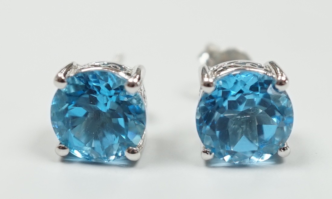 A modern pair of white metal (stamped 18) and single stone blue topaz set ear studs, 7mm, gross weight 3.1 grams.